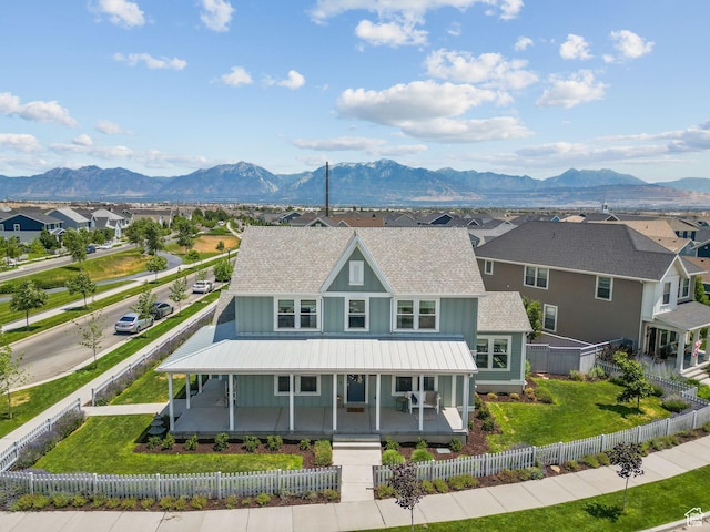 11571 S Skyward Rd W, South Jordan, UT 84009 - view of front of home with board and batten siding, a porch, a shingled roof, a mountain view, and a residential view