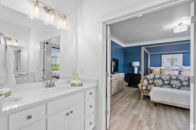 11571 S Skyward Rd W, South Jordan, UT 84009 - full bath with ensuite bath, wood finished floors, vanity, and a textured ceiling