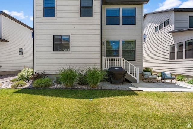 22 W Orchard Ln Unit 202, Bountiful, UT 84010 - back of house featuring a lawn and a patio area