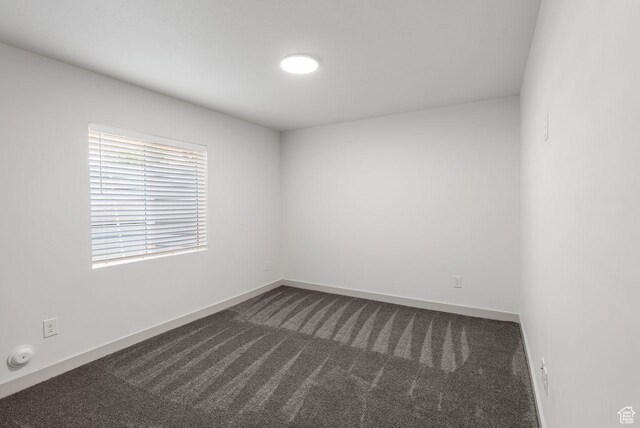 22 W Orchard Ln Unit 202, Bountiful, UT 84010 - empty room with dark colored carpet and baseboards