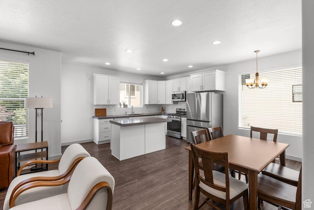 22 W Orchard Ln Unit 202, Bountiful, UT 84010 - kitchen with appliances with stainless steel finishes, a center island, plenty of natural light, dark wood finished floors, and recessed lighting