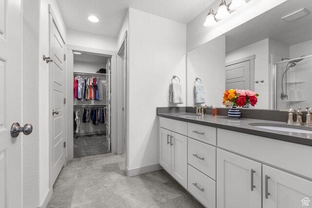 22 W Orchard Ln Unit 202, Bountiful, UT 84010 - full bath featuring double vanity, a stall shower, a walk in closet, and recessed lighting