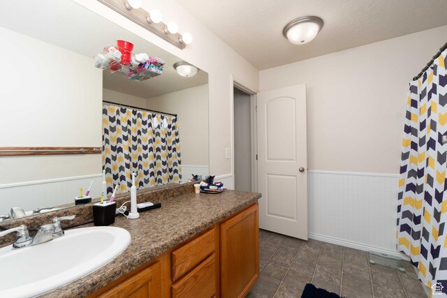 392 E 700 S Unit H, Vernal, UT 84078 - bathroom with a wainscoted wall, vanity, and a shower with shower curtain