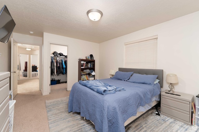 392 E 700 S Unit H, Vernal, UT 84078 - bedroom featuring light colored carpet, a closet, a textured ceiling, and a spacious closet