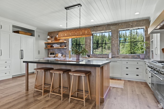 926 E Autumn Dr, Brian Head, UT 84719 - kitchen with open shelves, wood ceiling, paneled fridge, white cabinetry, and a center island