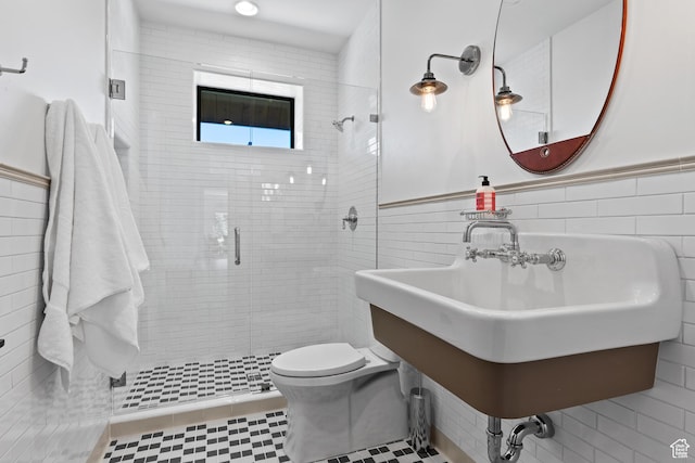 926 E Autumn Dr, Brian Head, UT 84719 - bathroom featuring tile walls, a shower stall, and a wainscoted wall