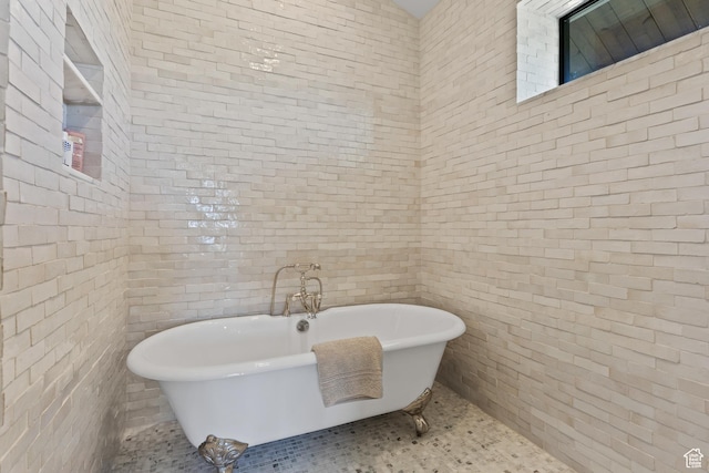 926 E Autumn Dr, Brian Head, UT 84719 - bathroom featuring a freestanding tub and brick wall