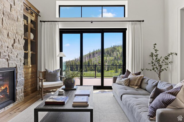 926 E Autumn Dr, Brian Head, UT 84719 - living room with a fireplace, wood finished floors, plenty of natural light, a towering ceiling, and a mountain view