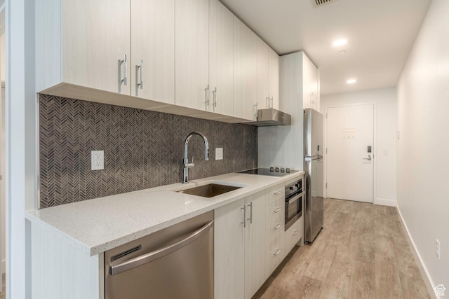 2303 Deer Hollow Rd Unit 2141, Park City, UT 84060 - kitchen with appliances with stainless steel finishes, backsplash, light wood-style flooring, extractor fan, and light stone countertops