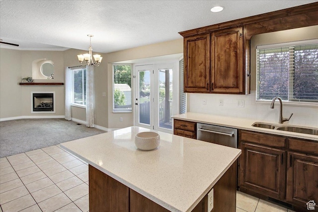 4595 W 1650 N, West Point, UT 84015 - kitchen featuring light colored carpet, a chandelier, a textured ceiling, light tile patterned flooring, and a fireplace