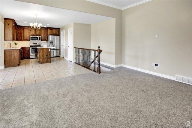 4595 W 1650 N, West Point, UT 84015 - kitchen featuring appliances with stainless steel finishes, a chandelier, crown molding, open floor plan, and light countertops