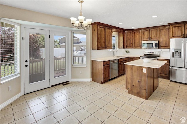 4595 W 1650 N, West Point, UT 84015 - kitchen featuring stainless steel appliances, a chandelier, light countertops, healthy amount of natural light, and recessed lighting