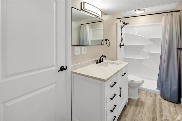 4595 W 1650 N, West Point, UT 84015 - bathroom with wood finished floors, vanity, curtained shower, and a textured ceiling