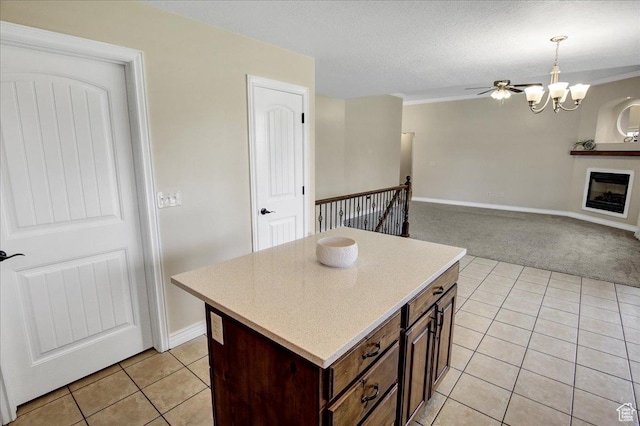 4595 W 1650 N, West Point, UT 84015 - kitchen with light tile patterned floors, light colored carpet, light countertops, a kitchen island, and a textured ceiling