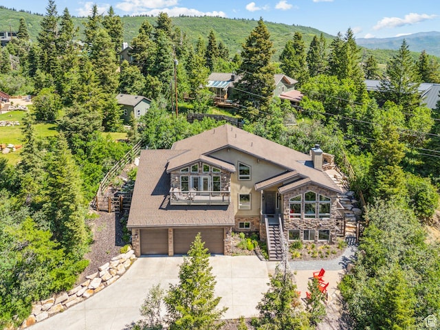 535 Crestview Dr, Park City, UT 84098 - view of front of home featuring stairs, stone siding, concrete driveway, a garage, and a balcony