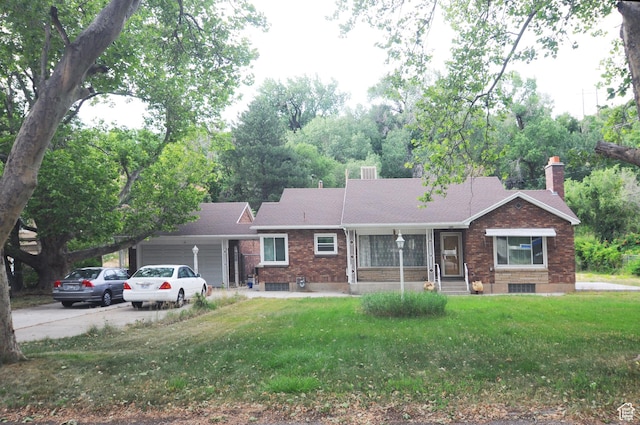 1160 E 12th St S, Ogden, UT 84404 - single story home with a garage, a chimney, concrete driveway, brick siding, and a front lawn