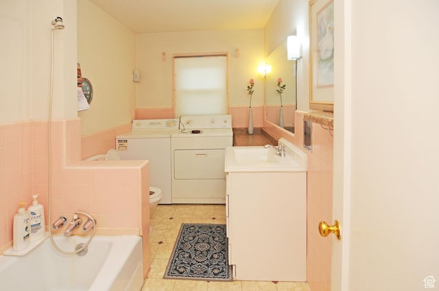 1160 E 12th St S, Ogden, UT 84404 - bathroom with washer and dryer, a bath, vanity, and tile patterned flooring
