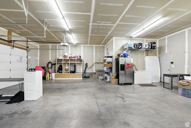 85 S 300 W, Smithfield, UT 84335 - garage featuring stainless steel fridge with ice dispenser, fridge, and a garage door opener