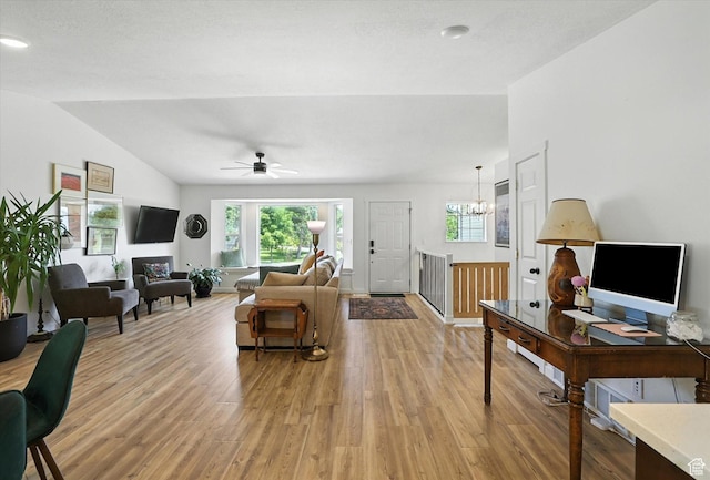 85 S 300 W, Smithfield, UT 84335 - living area with light wood-type flooring, vaulted ceiling, a chandelier, and a ceiling fan
