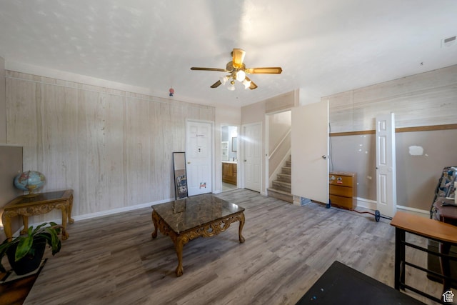 6231 S Westbrook Dr W, Taylorsville, UT 84129 - living room featuring a ceiling fan, stairs, wood finished floors, and wood walls