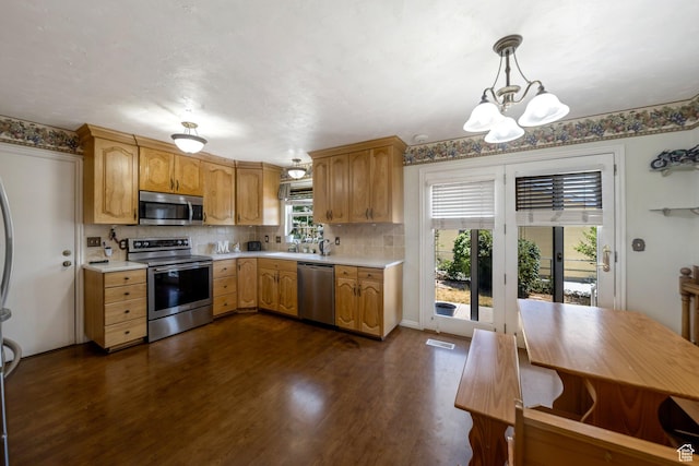 6231 S Westbrook Dr W, Taylorsville, UT 84129 - kitchen with appliances with stainless steel finishes, light countertops, a chandelier, and dark wood-style flooring