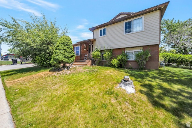 6231 S Westbrook Dr W, Taylorsville, UT 84129 - tri-level home with a front lawn and brick siding