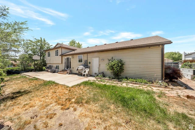 6231 S Westbrook Dr W, Taylorsville, UT 84129 - rear view of house with a patio area, entry steps, and a lawn