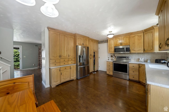6231 S Westbrook Dr W, Taylorsville, UT 84129 - kitchen featuring appliances with stainless steel finishes, light countertops, dark wood finished floors, and tasteful backsplash