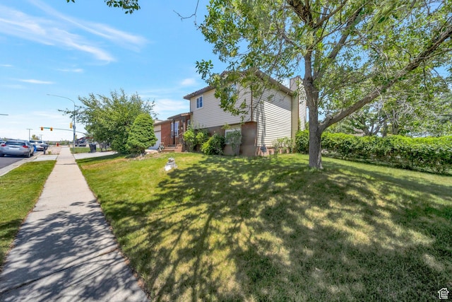 6231 S Westbrook Dr W, Taylorsville, UT 84129 - view of property exterior with a lawn