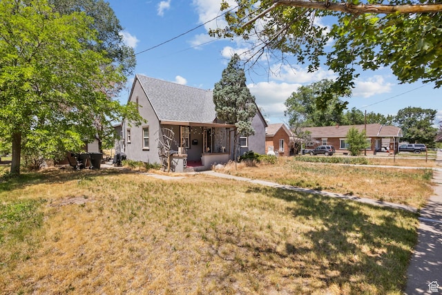 150 S 100 W, Tooele, UT 84074 - rear view of property with stucco siding, roof with shingles, and a yard