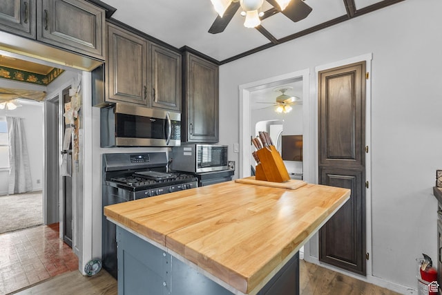 150 S 100 W, Tooele, UT 84074 - kitchen with a ceiling fan, wood counters, stainless steel microwave, and range with gas cooktop