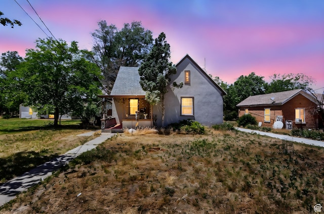 150 S 100 W, Tooele, UT 84074 - view of front facade featuring a porch, stucco siding, and a front yard