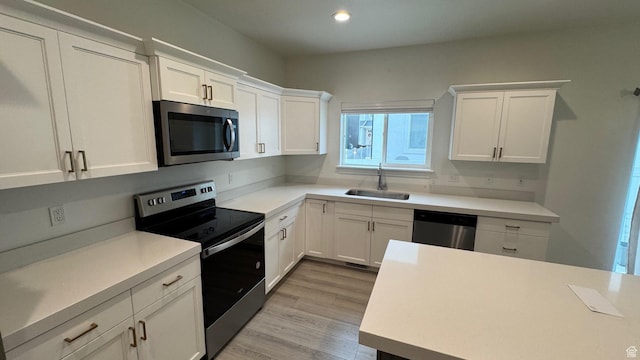 427 E 340 N, Vineyard, UT 84059 - kitchen with appliances with stainless steel finishes, white cabinetry, light countertops, light wood-type flooring, and recessed lighting