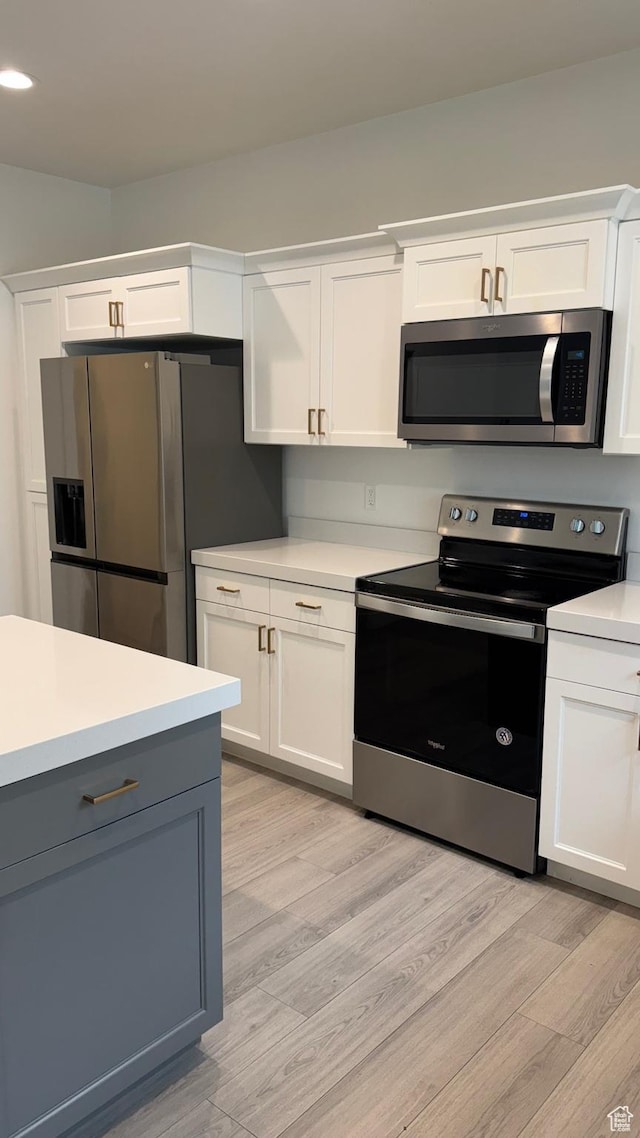 427 E 340 N, Vineyard, UT 84059 - kitchen featuring stainless steel appliances, light wood-style flooring, light countertops, white cabinetry, and recessed lighting