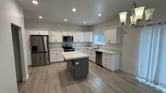 427 E 340 N, Vineyard, UT 84059 - kitchen featuring appliances with stainless steel finishes, white cabinets, light countertops, a chandelier, and light wood-style floors