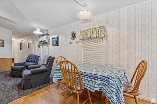 4400 W State St Unit 48, Hurricane, UT 84737 - dining room with wallpapered walls, wood finished floors, and ornamental molding