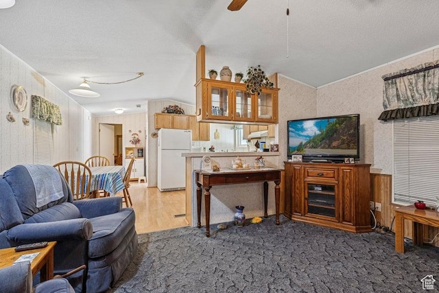 4400 W State St Unit 48, Hurricane, UT 84737 - carpeted living room with a textured ceiling, wallpapered walls, a ceiling fan, ornamental molding, and vaulted ceiling