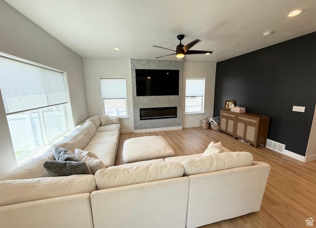 1258 E Bell Buoy Way, Eagle Mountain, UT 84005 - living area with ceiling fan, light wood-style flooring, a large fireplace, and recessed lighting