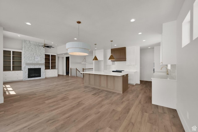 761 W 880 N, American Fork, UT 84003 - kitchen featuring ceiling fan, a kitchen island, recessed lighting, light countertops, and light wood-style flooring