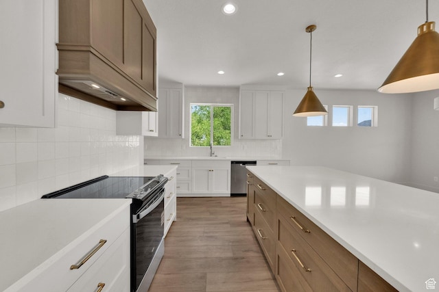 761 W 880 N, American Fork, UT 84003 - kitchen featuring appliances with stainless steel finishes, light countertops, white cabinetry, tasteful backsplash, and light wood-style flooring