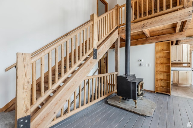 1796 W Tollgate Canyon Rd, Wanship, UT 84017 - stairs featuring a wood stove, hardwood / wood-style flooring, and beamed ceiling