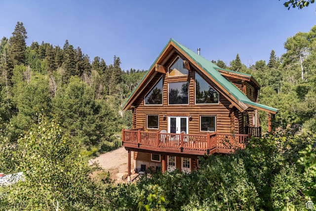 1796 W Tollgate Canyon Rd, Wanship, UT 84017 - back of house with log exterior, a wooden deck, french doors, and a view of trees