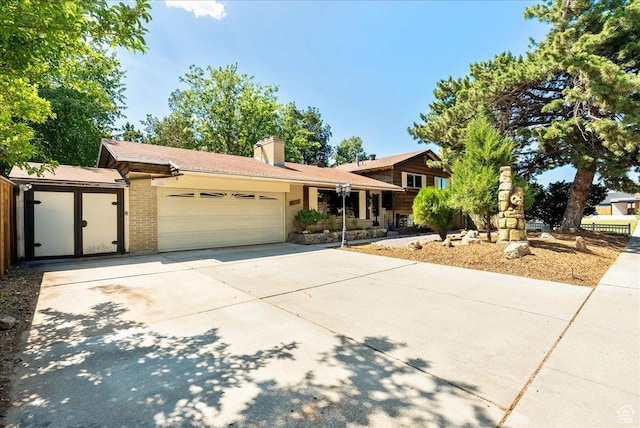 6690 S 1495 E, Cottonwood Heights, UT 84121 - split level home featuring a garage, driveway, and a chimney