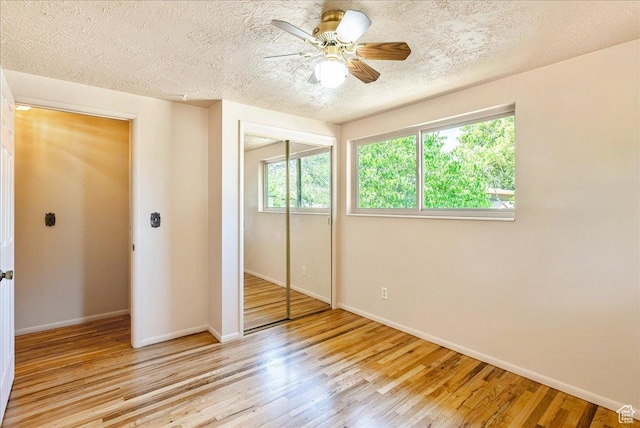 6690 S 1495 E, Cottonwood Heights, UT 84121 - unfurnished bedroom with wood finished floors, a textured ceiling, a closet, and a ceiling fan