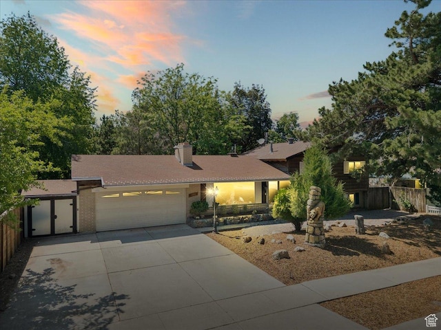 6690 S 1495 E, Cottonwood Heights, UT 84121 - view of front of property with a garage, concrete driveway, and a chimney
