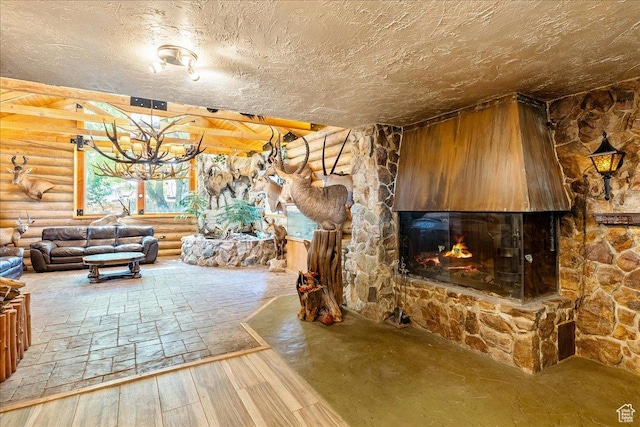6690 S 1495 E, Cottonwood Heights, UT 84121 - unfurnished living room featuring log walls, a fireplace, hardwood / wood-style floors, and a chandelier