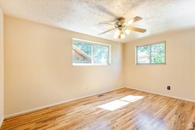 6690 S 1495 E, Cottonwood Heights, UT 84121 - empty room with healthy amount of natural light, wood finished floors, a ceiling fan, and a textured ceiling