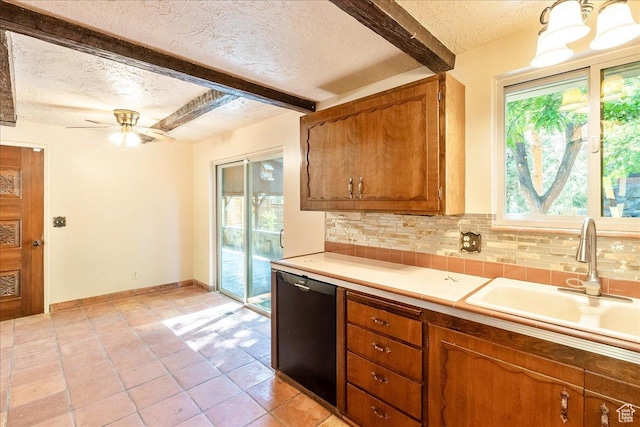 6690 S 1495 E, Cottonwood Heights, UT 84121 - kitchen with a textured ceiling, black dishwasher, beamed ceiling, light countertops, and tasteful backsplash