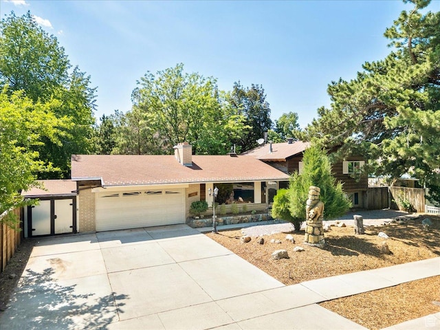 6690 S 1495 E, Cottonwood Heights, UT 84121 - view of front of home with an attached garage, driveway, a chimney, and brick siding
