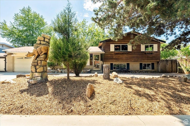 6690 S 1495 E, Cottonwood Heights, UT 84121 - tri-level home featuring an attached garage and driveway